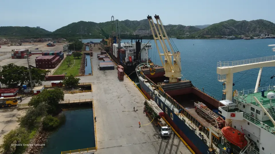 Cargo vessel alongside a quay with cranes and operating areas