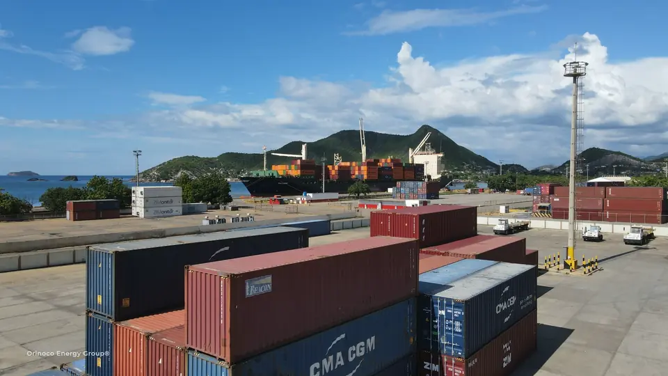 Container yard with stacks and the vessel beyond