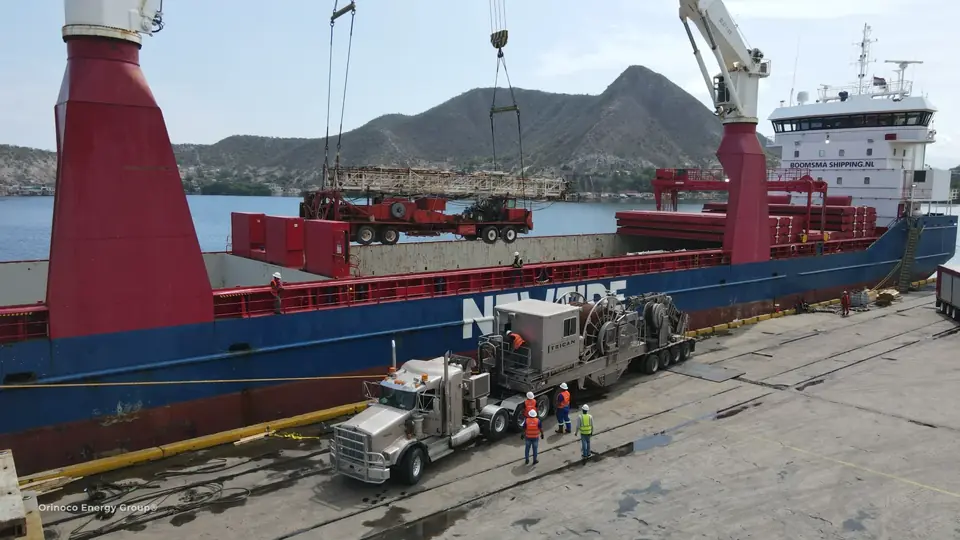 Industrial equipment lifted from a vessel towards waiting transport