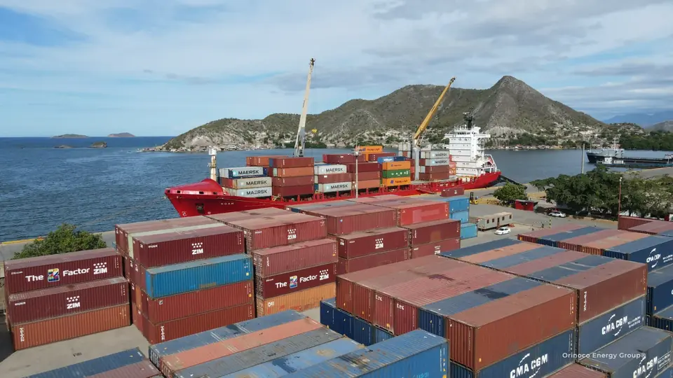 Container yard with a vessel and mountains beyond