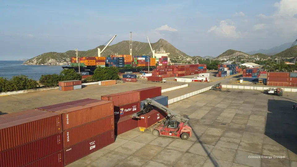 Container yard and handling equipment beside a vessel